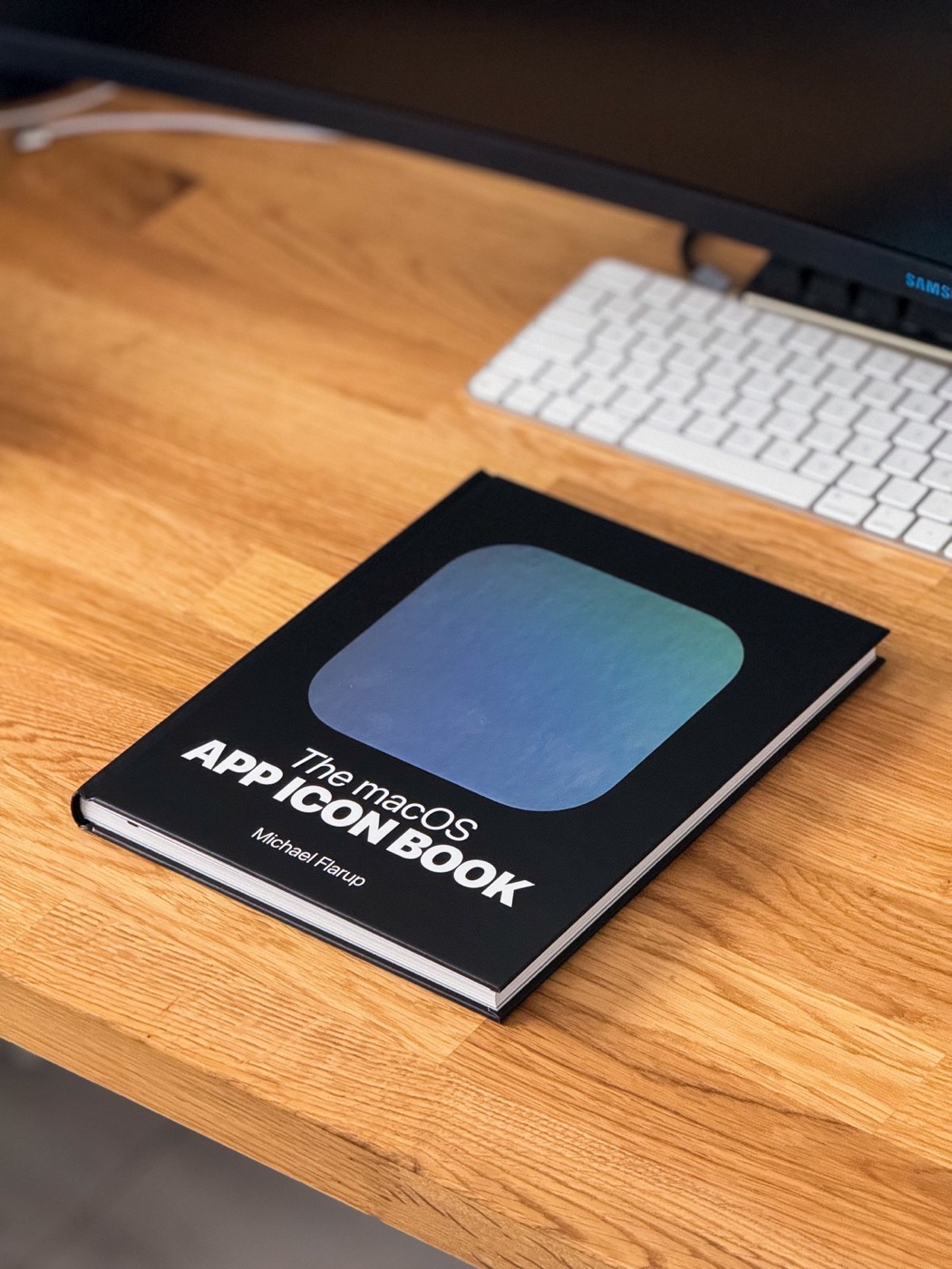 The macOS App Icon Book resting on a wooden desk